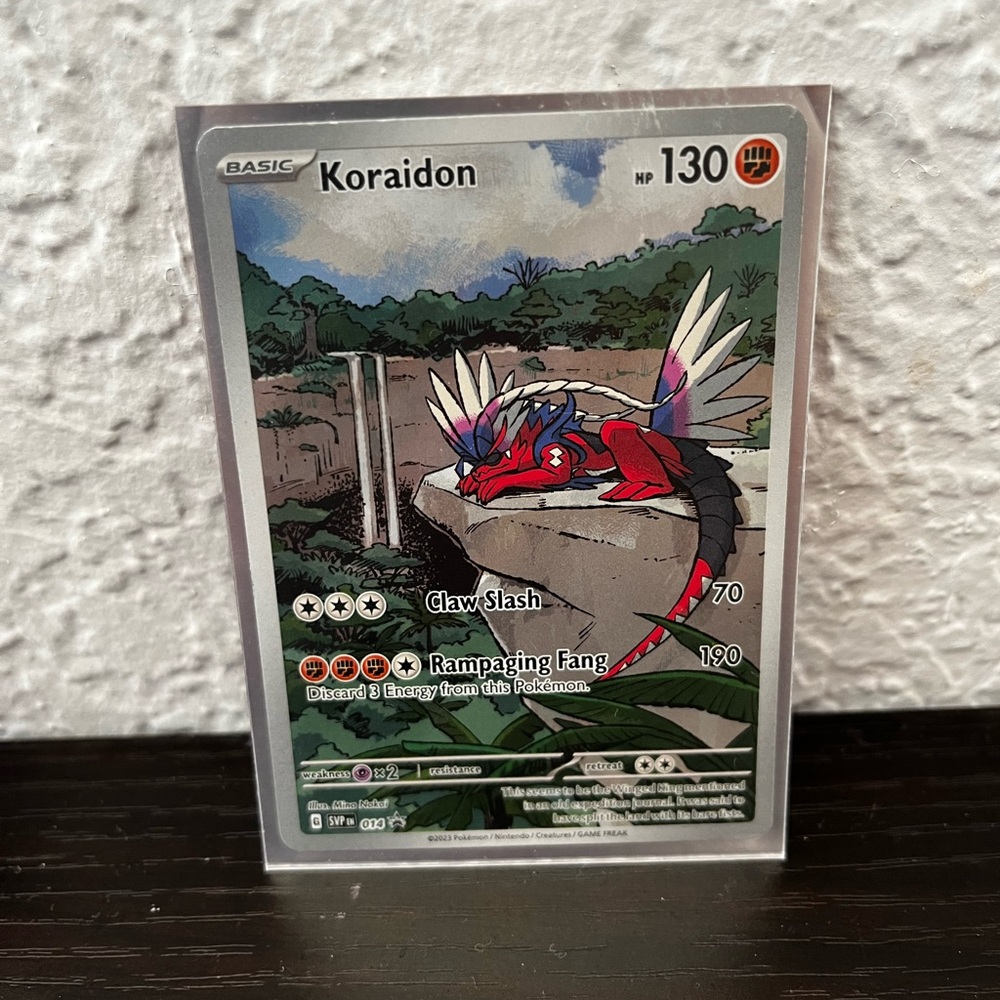 Koraidon Pokémon Card with Red and Blue Accents